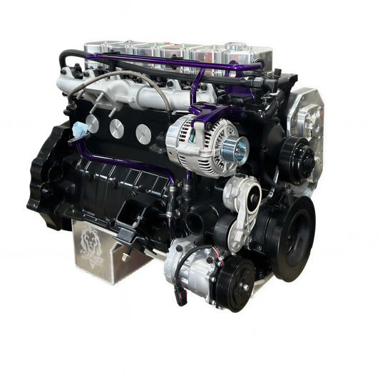 A high-performance V8 engine with a black and silver painted finish, featuring purple anodized metal guide rods, a polished silver intake manifold, and various pulleys and belts, isolated on a white background.